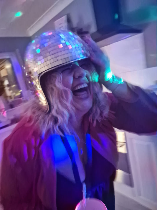 Donna Timlin Beauty Specialist photographed in disco ball hat