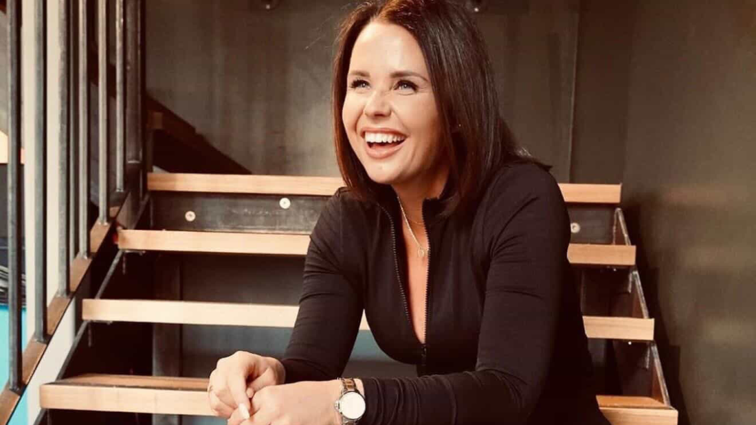 Jordan Stachini sits on stairs smiling