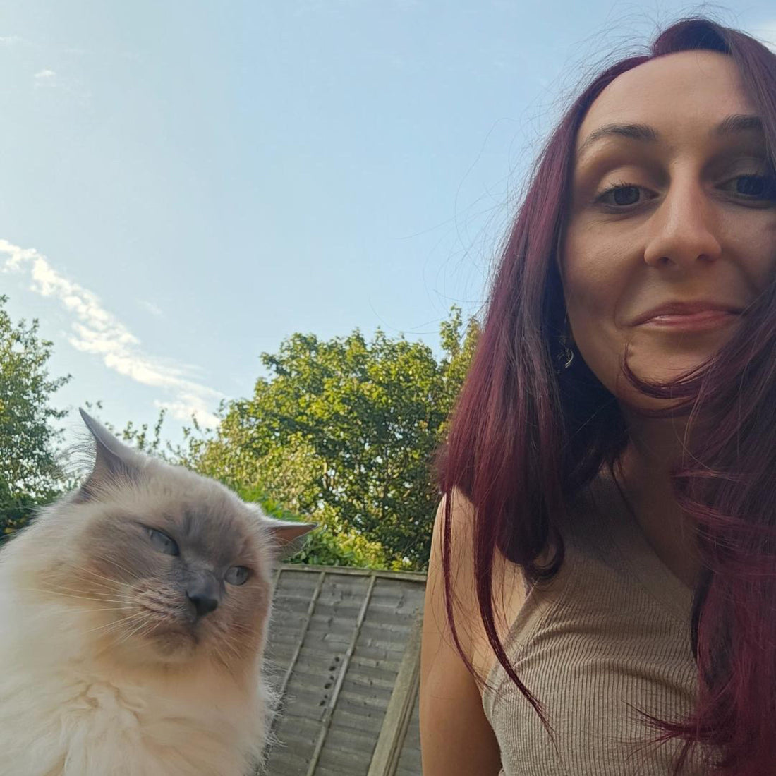 Dr Katie Ford, UK veterinary surgeon and keynote speaker, smiling with her cat — symbolising her journey from imposter syndrome to self-worth.