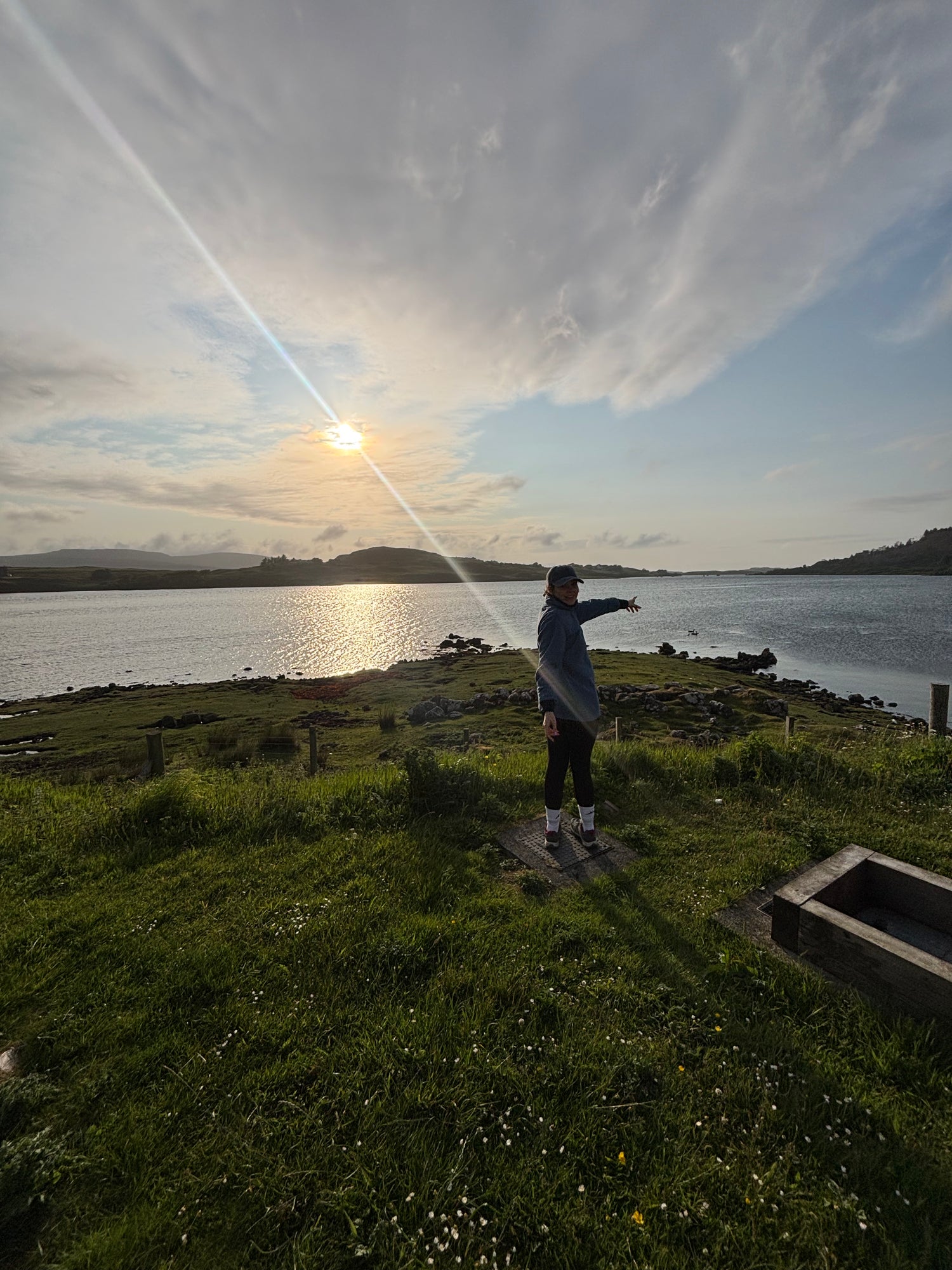 Founder Beth Wright pointing at the Scottish loch